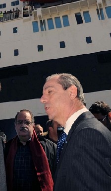 Malta's Prime Minister Lawrence Gonzi in front of a ship evacuating foreigners from Libya